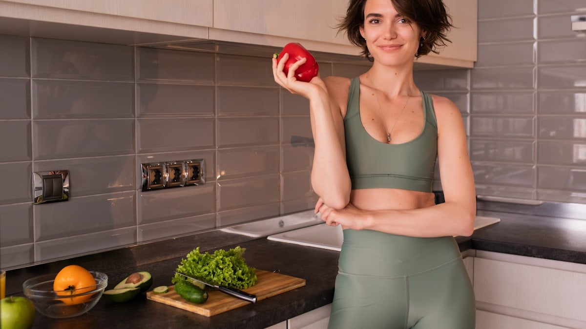 Photo Of Young Woman With Vegetables At The Kitchen.